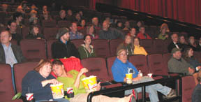Audience at the Yelm Cinemas snacks out while waiting for the movie to begin . . . 